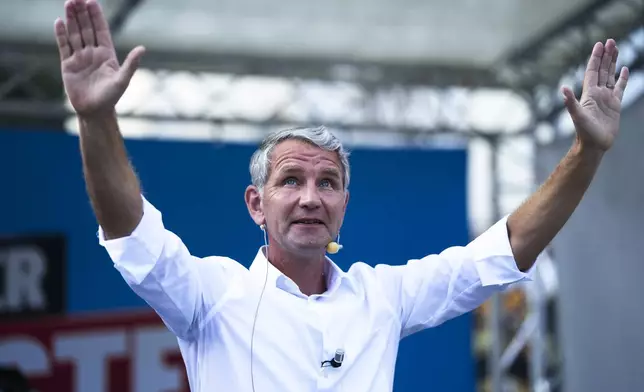 Bjoern Hoecke top candidate in Thuringia of the far-right Alternative for Germany, AfD, party waves to supporters during an election campaign rally in Suhl, Germany, Aug. 13, 2024. (AP Photo/Markus Schreiber)