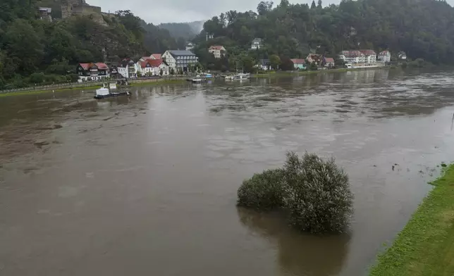 View of the river Elbe in flood, in Rathen, Germany, Monday Sept. 16, 2024. The water levels continue to rise in Saxony. (Jan Woitas/dpa via AP)