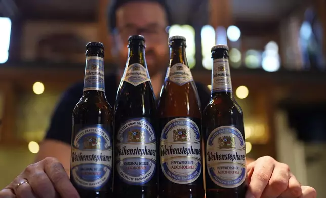 Head Brewmaster Tobias Zollo poses behind non alcoholic beer at the Weihenstephan brewery in Freising, Germany, Friday, Sept. 20, 2024. (AP Photo/Matthias Schrader)