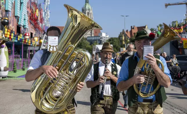 A brass band plays during a press tour at the Oktoberfest, in Munich, Germany, Thursday, Sept. 19, 2024. (Lennart Preiss/dpa via AP)