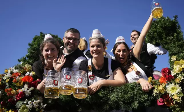 The Oktoberfest hosts arrive for the start of the 189th 'Oktoberfest' beer festival in Munich, Germany, Saturday, Sept. 21, 2024. (AP Photo/Matthias Schrader)