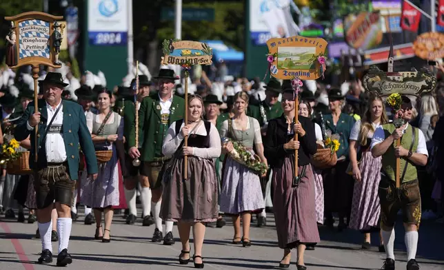 The traditional Oktoberfest music bands parade at the start of the 189th 'Oktoberfest' beer festival in Munich, Germany, Saturday, Sept. 21, 2024. (AP Photo/Matthias Schrader)