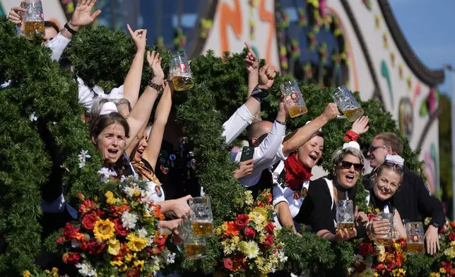 The Oktoberfest hosts arrive for the start of the 189th 'Oktoberfest' beer festival in Munich, Germany, Saturday, Sept. 21, 2024. (AP Photo/Matthias Schrader)