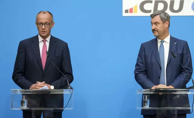 German opposition leader and Christian Democratic Union party chairman Friedrich Merz, left, talks to the media beside Markus Soeder, Christian Social Union party leader and state governor of Bavaria, right, at a joint news conference in Berlin, Germany, Tuesday, Sept. 17, 2024. (AP Photo/Markus Schreiber)