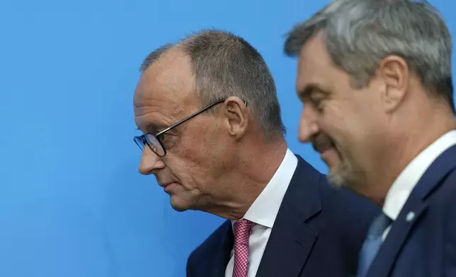 German opposition leader and Christian Democratic Union party chairman Friedrich Merz, left, and Markus Soeder, Christian Social Union party leader and state governor of Bavaria, leave a joint news conference in Berlin, Germany, Tuesday, Sept. 17, 2024. (AP Photo/Markus Schreiber)