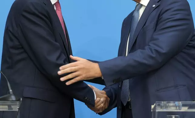 German opposition leader and Christian Democratic Union party chairman Friedrich Merz, left, and Markus Soeder, Christian Social Union party leader and state governor of Bavaria, shake hands at a joint news conference in Berlin, Germany, Tuesday, Sept. 17, 2024. (AP Photo/Markus Schreiber)