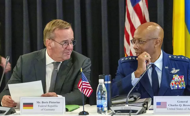 German's Defense Minister Boris Pistorius, left, and Chairman of the Joint Chiefs of Staff Air Force of the U.S. Gen. CQ Brown talk during a meeting with U.S. Defense Secretary Lloyd Austin and Ukraine's President Volodymyr Zelenskyy at Ramstein Air Base in Ramstein-Miesenbach, Germany, Friday, Sept. 6, 2024. (Andreas Arnold/dpa via AP)