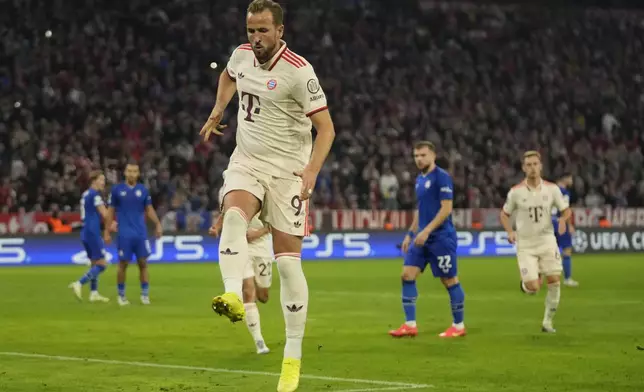 Bayern's Harry Kane celebrates after scoring the opening goal from the penalty sport during the Champions League opening phase soccer match between Bayern Munich and GNK Dinamo at the Allianz Arena in Munich, Germany Tuesday, Sept. 17, 2024. (AP Photo/Matthias Schrader)