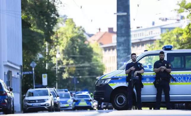 Police officers block a street after police fired shots at a suspicious person near the Israeli Consulate and a museum on the city's Nazi-era history in Munich, Germany, Thursday, Sept. 5, 2024. (AP Photo/Matthias Schrader)