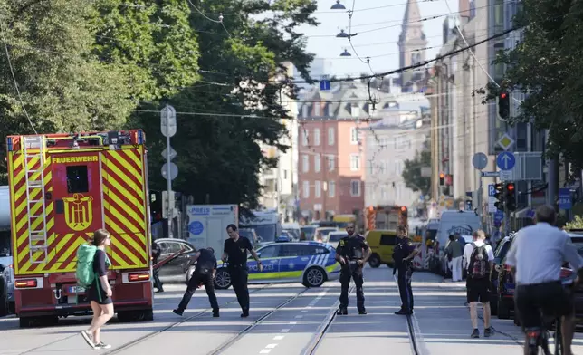 Police officers block a street after police fired shots at a suspicious person near the Israeli Consulate and a museum on the city's Nazi-era history in Munich, Germany, Thursday, Sept. 5, 2024. (AP Photo/Matthias Schrader)