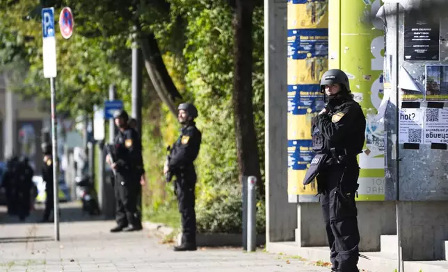 Police officers patrol after police fired shots at a suspicious person near the Israeli Consulate and a museum on the city's Nazi-era history in Munich, Germany, Thursday, Sept. 5, 2024. (AP Photo/Matthias Schrader)