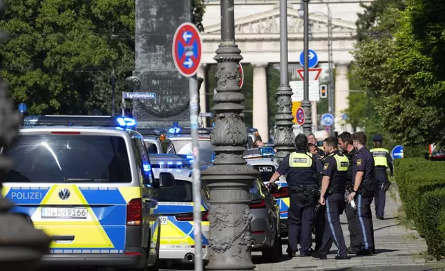 Police officers stand at a street after police fired shots at a suspicious person near the Israeli Consulate and a museum on the city's Nazi-era history in Munich, Germany, Thursday, Sept. 5, 2024. (AP Photo/Matthias Schrader)