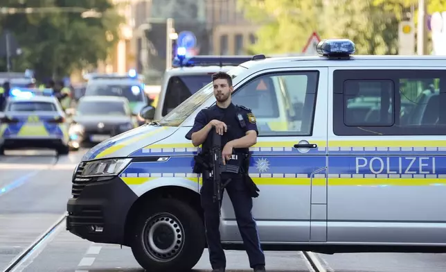 Police officer block a street after police fired shots at a suspicious person near the Israeli Consulate and a museum on the city's Nazi-era history in Munich, Germany, Thursday, Sept. 5, 2024. (AP Photo/Matthias Schrader)