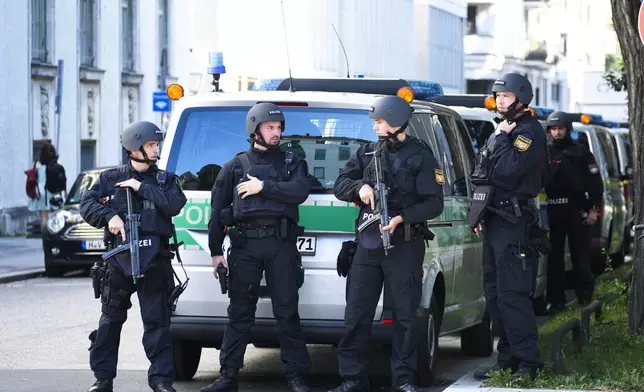 Police officers patrol after police fired shots at a suspicious person near the Israeli Consulate and a museum on the city's Nazi-era history in Munich, Germany, Thursday, Sept. 5, 2024. (AP Photo/Matthias Schrader)