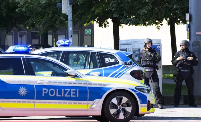 Police officer block a street after police fired shots at a suspicious person near the Israeli Consulate and a museum on the city's Nazi-era history in Munich, Germany, Thursday, Sept. 5, 2024. (AP Photo/Matthias Schrader)