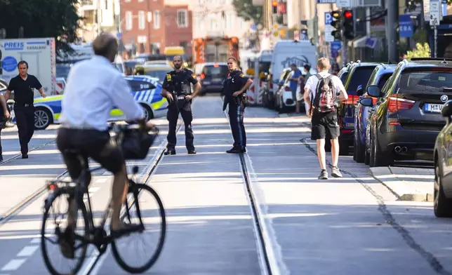 Police officers block a street after police fired shots at a suspicious person near the Israeli Consulate and a museum on the city's Nazi-era history in Munich, Germany, Thursday, Sept. 5, 2024. (AP Photo/Matthias Schrader)