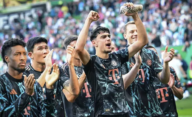 Bayern's players celebrate after the German Bundesliga soccer match between SV Werder Bremen and Bayern Munich in Bremen, Germany, Saturday, Sept. 21, 2024. (Sina Schuldt/dpa via AP)