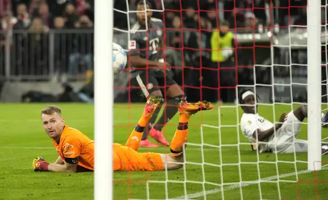 Leverkusen's goalkeeper Lukas Hradecky looks at the ball hitting the post during the Bundesliga soccer match between Bayern Munich and Leverkusen at the Allianz Arena in Munich, Germany, Saturday, Sept. 28, 2024. (AP Photo/Matthias Schrader)