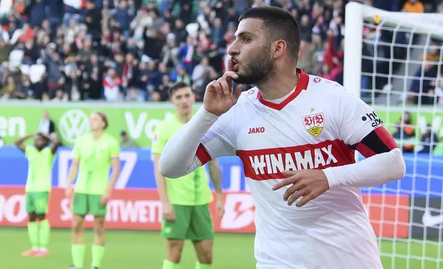 Stuttgart's Deniz Undav celebrates after scoring his side's second goal during the German Bundesliga soccer match between VfL Wolfsburg and VfB Stuttgart at the Volkswagen Arena, in Wolfsburg, Germany, Sept. 28, 2024. (Swen Pförtner/dpa via AP)