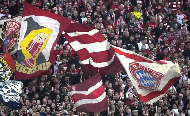 Supporters cheer during the Bundesliga soccer match between Bayern Munich and Leverkusen at the Allianz Arena in Munich, Germany, Saturday, Sept. 28, 2024. (AP Photo/Matthias Schrader)