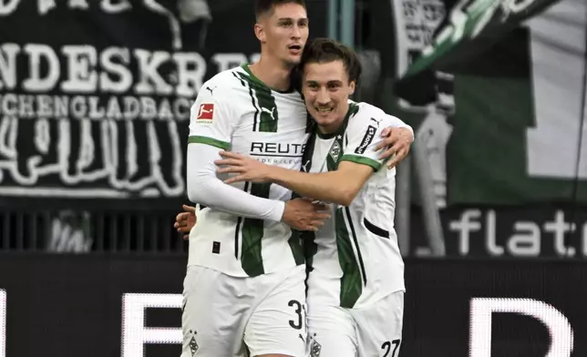 Mönchengladbach's Tomas Cvancara, left, celebrates after scoring the opening goal with Rocco Reitz during the German Bundesliga soccer match between Borussia Mönchengladbach and 1. FC Union Berlin at Borussia-Park stadium, in Mönchengladbach, Germany, Sept. 28, 2024. (Federico Gambarini/dpa via AP)