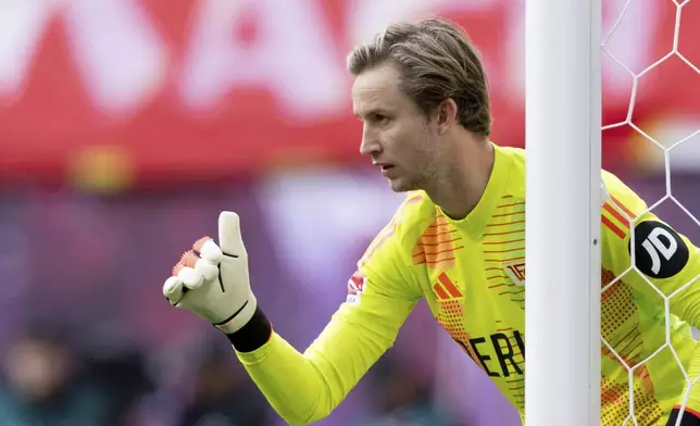 Berlin goalkeeper Frederik R'nnow reacts on the pitch during a match between RB Leipzig and FC Union Berlin in Leipzig, Germany, Saturday, Sept. 14, 2024. (Hendrik Schmidt/dpa via AP)