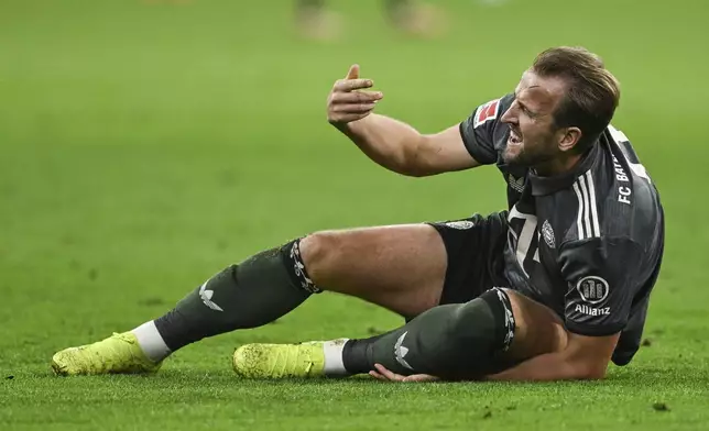 Munich's Harry Kane lies on the pitch in pain during the German Bundesliga soccer match between Bayern Munich and Leverkusen at the Allianz Arena in Munich, Germany, Saturday, Sept. 28, 2024. (Sven Hoppe/dpa via AP)