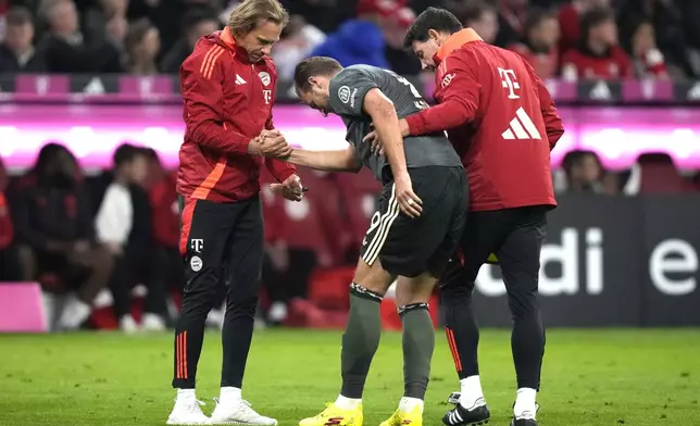 Bayern's Harry Kane leaves the pitch after being injured during the Bundesliga soccer match between Bayern Munich and Leverkusen at the Allianz Arena in Munich, Germany, Saturday, Sept. 28, 2024. (AP Photo/Matthias Schrader)