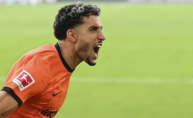 Frankfurt's Omar Marmoush celebrates after scoring, during the German Bundesliga soccer match between VfL Wolfsburg and Eintracht Frankfurt, at the Volkswagen Arena, in Wolfsburg, Germany, Saturday, Sept. 14, 2024. (Swen Pförtner/dpa via AP)