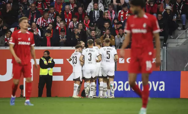 St. Pauli's players celebrate after Elias Saad scored the opening goal during the German Bundesliga soccer match between SC Freiburg and FC St. Pauliat the Europa-Park stadium, in Freiburg im Breisgau, Germany, Sept. 28, 2024. (Philipp von Ditfurth/dpa via AP)