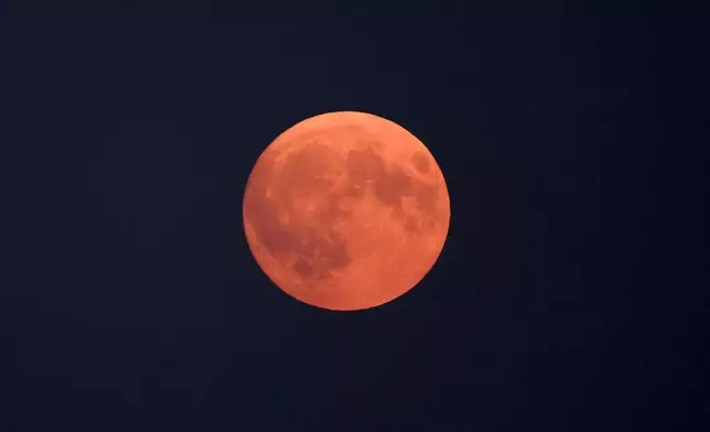 The full Harvest moon rises in Berlin, Germany, Tuesday, Sept. 17, 2024. (AP Photo/Markus Schreiber)