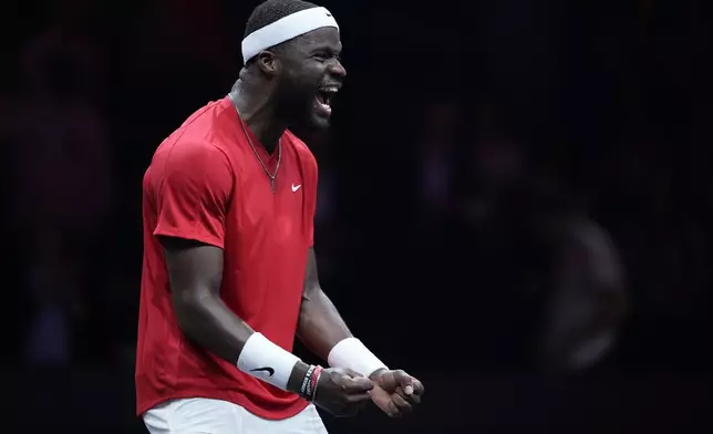 Team World's Frances Tiafoe celebrates after he beat =med- on the second day of the Laver Cup tennis tournament at the Uber arena in Berlin, Germany, Saturday, Sept. 21, 2024. (AP Photo/Ebrahim Noroozi)