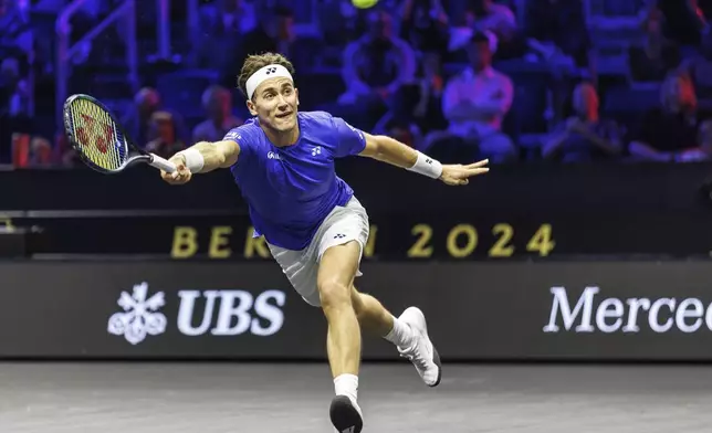 Casper Ruud returns a ball to Argentina's Francisco Cerundolo during their men's singles Laver Cup tennis match at the Uber Arena in Berlin, Germany, Friday Sept. 20, 2024. (Andreas Gora/dpa via AP)