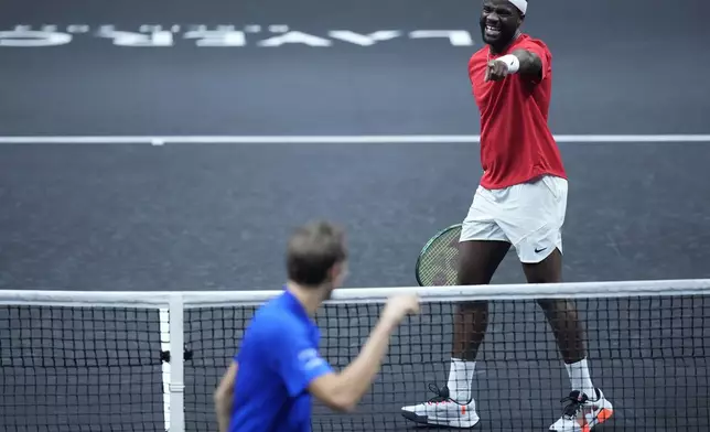 Team World's Frances Tiafoe, right, shares a light moment with Team Europe's Daniil Medvedev on the second day of the Laver Cup tennis tournament at the Uber arena in Berlin, Germany, Saturday, Sept. 21, 2024. (AP Photo/Ebrahim Noroozi)