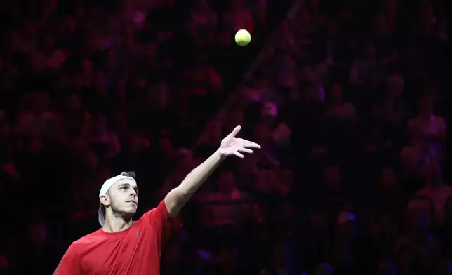 Team World's Francisco Cerundolo tosses the ball for a serve to Europe's Casper Ruud during his singles tennis match on the first day of the Laver Cup tennis tournament at the Uber arena in Berlin, Germany, Friday, Sept. 20, 2024. (AP Photo/Ebrahim Noroozi)