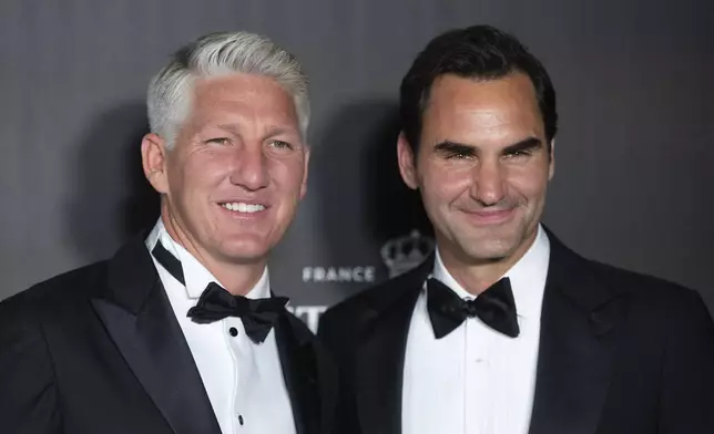 Former Tennis player Roger Federer, right, and the former soccer player, Bastian Schweinsteiger, left, attend the Opening Night of the Laver Cup tennis tournament in Berlin, Germany, Thursday, Sept. 19, 2024. (Christophe Gateau/dpa via AP)