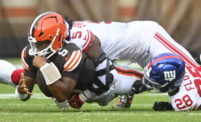 Cleveland Browns quarterback Jameis Winston, foreground left, is tackled by New York Giants linebacker Kayvon Thibodeaux during the second half of an NFL football game, Sunday, Sept. 22, 2024, in Cleveland. (AP Photo/David Richard)