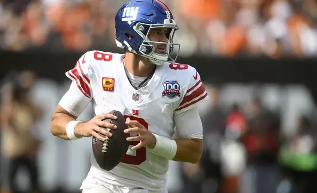 New York Giants quarterback Daniel Jones rolls out to pass against the Cleveland Browns during the second half of an NFL football game, Sunday, Sept. 22, 2024, in Cleveland. (AP Photo/David Richard)