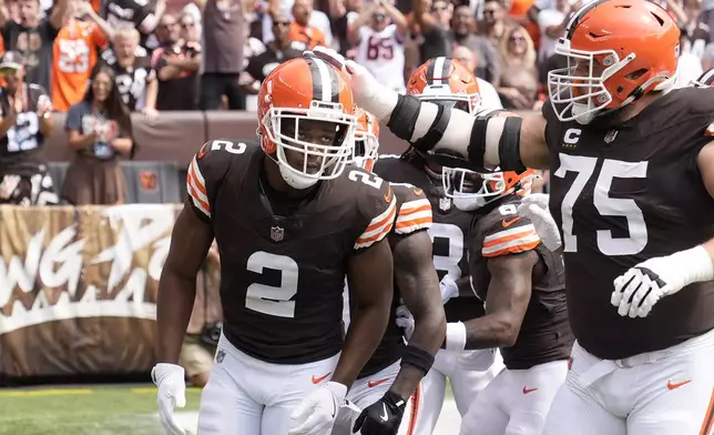 Cleveland Browns wide receiver Amari Cooper (2) is congratulated by guard Joel Bitonio (75) after scoring against the New York Giants during the first half of an NFL football game, Sunday, Sept. 22, 2024 in Cleveland. (AP Photo/Sue Ogrocki)