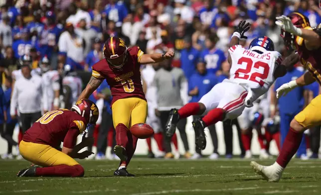 Washington Commanders place kicker Austin Seibert (3) kicks a field goal against the New York Giants' Dru Phillips (22) during the first half of an NFL football game in Landover, Md., Sunday, Sept. 15, 2024. (AP Photo/Steve Ruark)