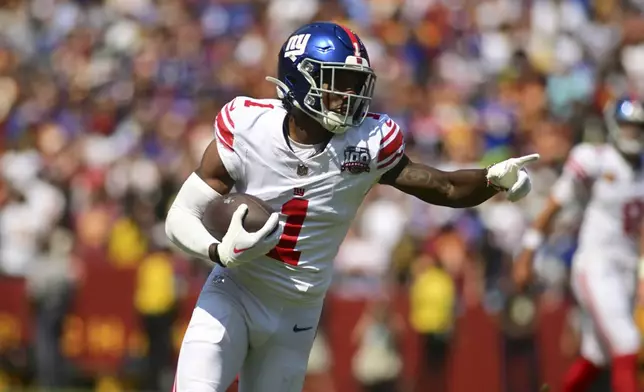 New York Giants wide receiver Malik Nabers (1) runs after a catch against the Washington Commanders during the first half of an NFL football game in Landover, Md., Sunday, Sept. 15, 2024. (AP Photo/Steve Ruark)