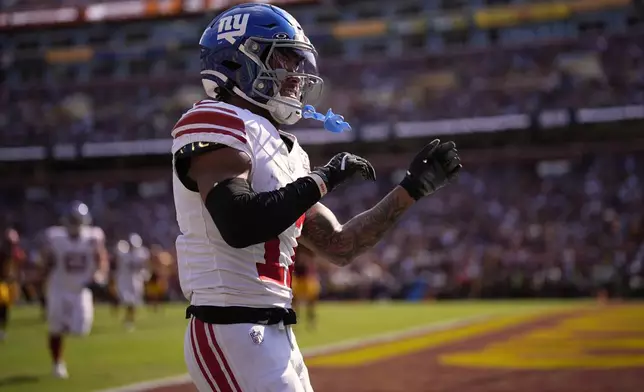 New York Giants wide receiver Wan'Dale Robinson (17) celebrates his touchdown against the Washington Commanders during the second half of an NFL football game in Landover, Md., Sunday, Sept. 15, 2024. (AP Photo/Matt Slocum)