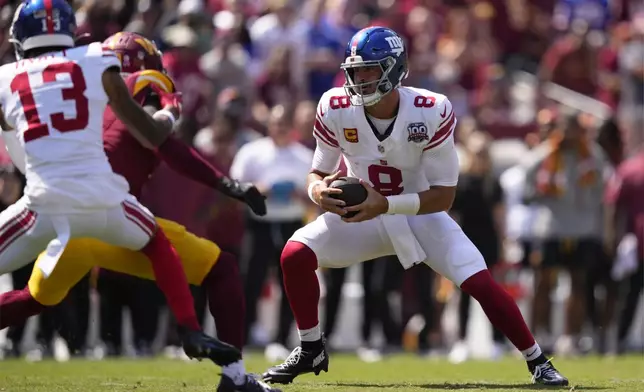 New York Giants quarterback Daniel Jones (8) scrambles against the Washington Commanders during the first half of an NFL football game in Landover, Md., Sunday, Sept. 15, 2024. (AP Photo/Matt Slocum)