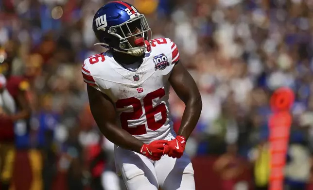 New York Giants running back Devin Singletary (26) celebrates his touchdown run against the Washington Commanders during the first half of an NFL football game in Landover, Md., Sunday, Sept. 15, 2024. (AP Photo/Steve Ruark)