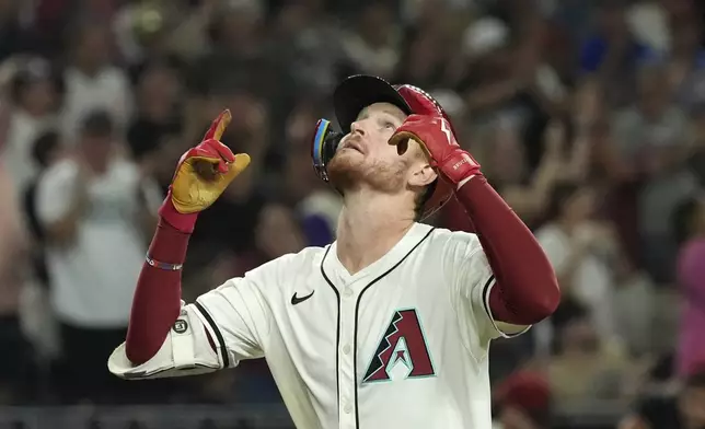 Arizona Diamondbacks' Pavin Smith looks up as he rounds the bases after hitting a three-run home run against the San Francisco Giants during the eighth inning of a baseball game Wednesday, Sept. 25, 2024, in Phoenix. (AP Photo/Ross D. Franklin)