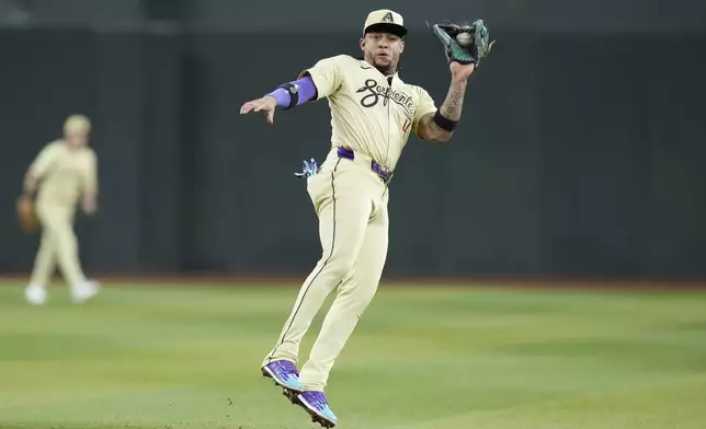 Arizona Diamondbacks second baseman Ketel Marte makes a leaping catch on a liner hit by San Francisco Giants' Patrick Bailey during the seventh inning of a baseball game Tuesday, Sept. 24, 2024, in Phoenix. (AP Photo/Ross D. Franklin)