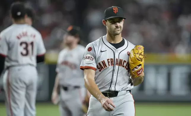 San Francisco Giants starting pitcher Mason Black walks off the field after being replaced during the third inning of a baseball game against the Arizona Diamondbacks, Wednesday, Sept. 25, 2024, in Phoenix. (AP Photo/Ross D. Franklin)