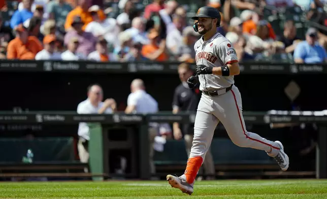 San Francisco Giants' Michael Conforto (8) runs home after hitting a home run during the fourth inning of a baseball game against the Baltimore Orioles, Thursday, Sept. 19, 2024, in Baltimore. (AP Photo/Stephanie Scarbrough)