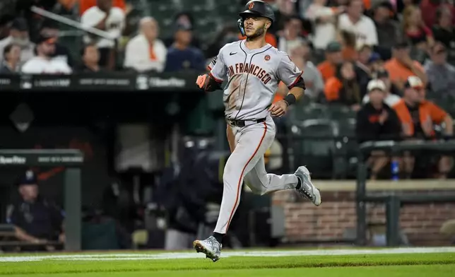 San Francisco Giants' Grant McCray advances toward home plate to score on an RBI single hit in by Donovan Walton during the fourth inning of a baseball game against the Baltimore Orioles, Tuesday, Sept. 17, 2024, in Baltimore. (AP Photo/Stephanie Scarbrough)