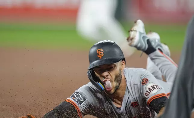 San Francisco Giants' Grant McCray slides into first base after running through on a single line drive during the fourth inning of a baseball game against the Baltimore Orioles, Tuesday, Sept. 17, 2024, in Baltimore. (AP Photo/Stephanie Scarbrough)